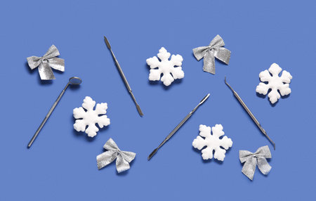 Dental tools with Christmas decor on blue backgroundの写真素材