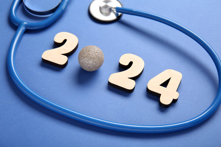 Figure 2024 with Christmas ball and stethoscope on blue backgroundの写真素材