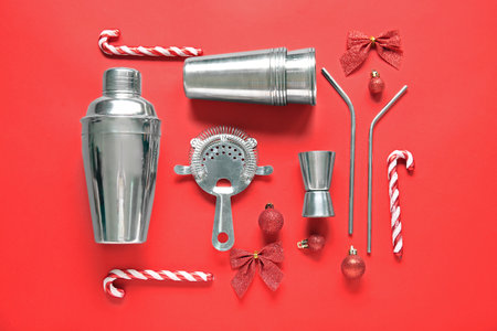 Bartender's supplies with Christmas decor on red backgroundの写真素材