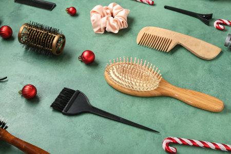 Hairdressing tools with Christmas decor on green backgroundの写真素材