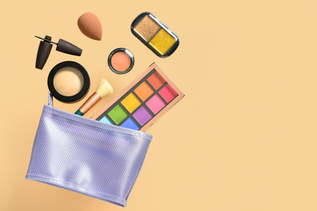 Cosmetic bag with different makeup products on yellow backgroundの写真素材