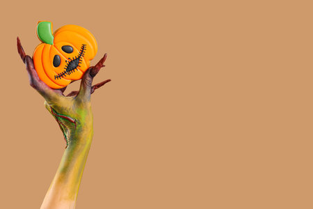 Witch with cookies on beige background. Halloween celebrationの写真素材