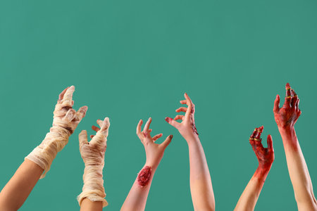 Zombie and mummy hands on green background. Halloween celebrationの写真素材