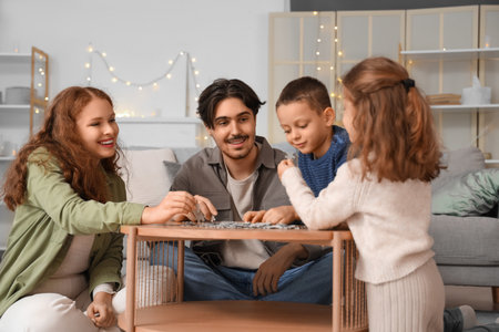 Happy family doing puzzle at homeの写真素材