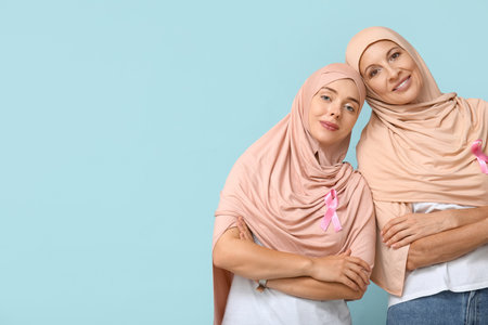 Muslim women with pink ribbons on blue background. Breast cancer awareness conceptの写真素材