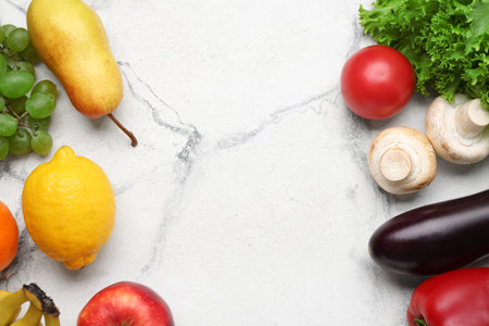 Frame made of fresh vegetables and fruits on white marble background. World Vegan Day conceptの写真素材