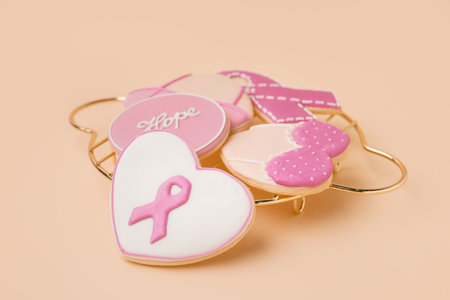 Pink cookies with ribbons and word HOPE on beige background. Breast cancer awareness conceptの写真素材