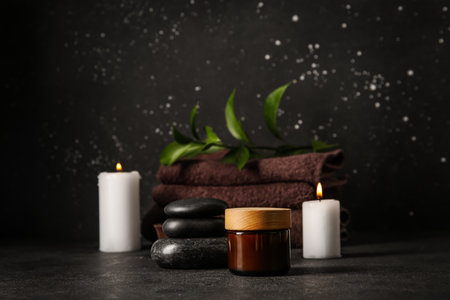 Jar with cream and spa stones on black backgroundの写真素材