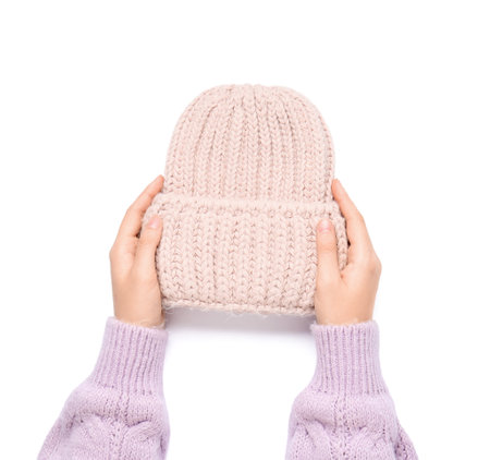 Female hands with knitted warm hat isolated on white background, closeupの写真素材