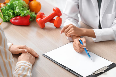 Female nutritionist working with patient in office, closeupの写真素材