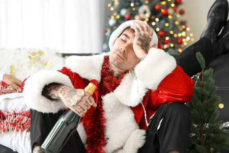 Drunk young man in Santa costume after Christmas party