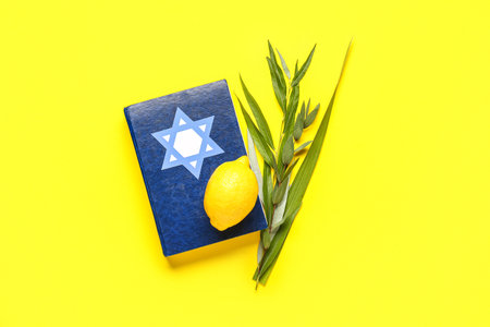 Four species (lulav, hadas, arava, etrog) as Sukkot festival symbols and Torah on yellow background