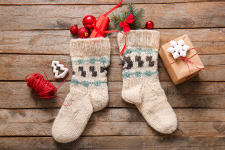 Christmas sock with beautiful decorations and gift boxes on wooden backgroundの写真素材