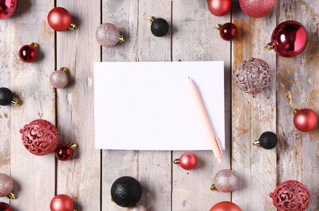 Beautiful composition with blank card and Christmas balls on gray wooden backgroundの写真素材