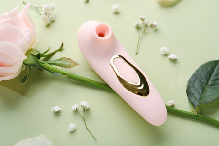 Vibrator with flowers on green background, closeupの写真素材