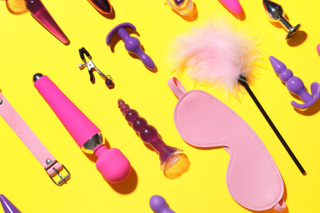 Different sex toys on yellow backgroundの写真素材