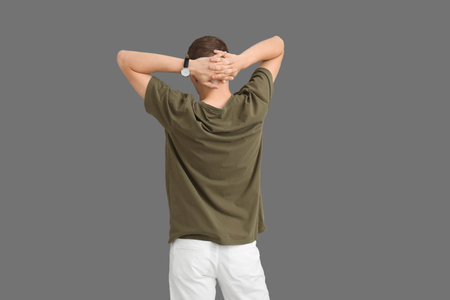Man in stylish t-shirt on gray background, back viewの写真素材