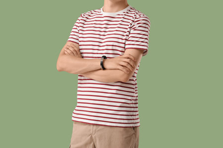 Man in stylish t-shirt on green backgroundの写真素材