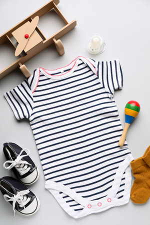 Composition with baby clothes, accessories and toys on gray backgroundの写真素材