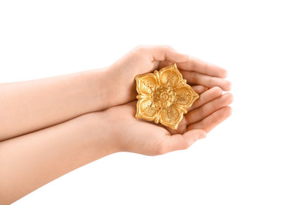 Female hands with golden diya lamp for celebration of Divaly on white background, closeupの写真素材