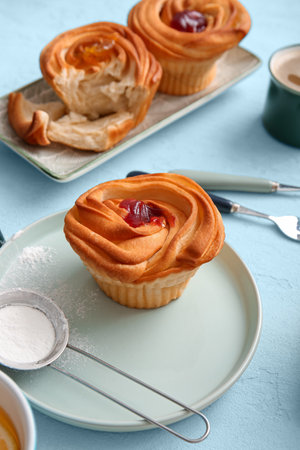 Plates of tasty cruffins with jam on white backgroundの写真素材