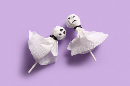 Sweet lollipops for Halloween party on purple backgroundの写真素材