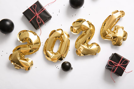 Figure 2024 made of balloons, Christmas balls and gifts on white backgroundの写真素材