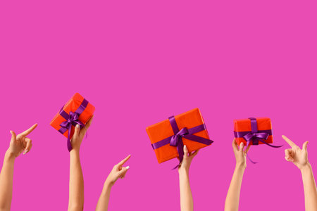 Women pointing at Halloween gifts on purple backgroundの写真素材