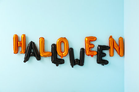 Word HALLOWEEN made of balloons on blue wallの写真素材