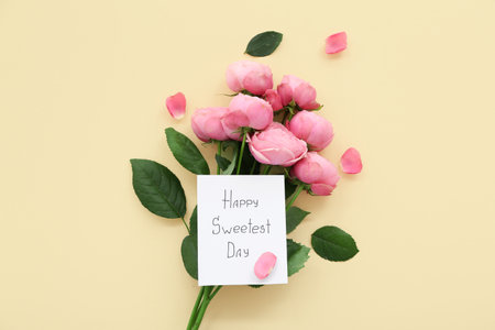 Greeting card with text HAPPY SWEETEST DAY and bouquet of rose flowers on yellow background. National Sweetest Dayの写真素材