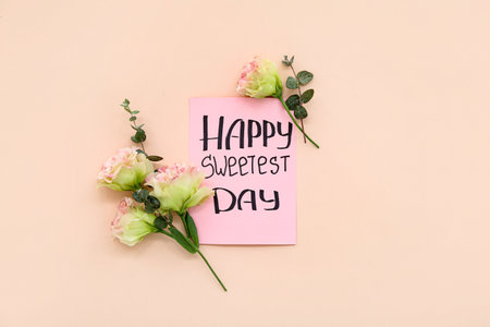 Greeting card with text HAPPY SWEETEST DAY and carnation flowers on pink background. National Sweetest Dayの写真素材