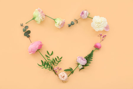 Heart made from flowers on beige background. National Sweetest Dayの写真素材
