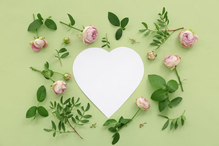 Blank heart with roses and leaves on green background. Sweetest Day celebrationの写真素材