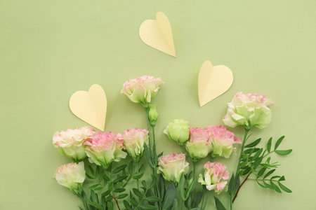 Roses with paper hearts on green background. Sweetest Day celebrationの写真素材