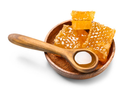Wooden spoon of sweet honey and plate with combs on white backgroundの写真素材
