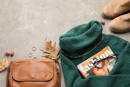 Composition with stylish female accessories, clothes and autumn decor on grunge backgroundの写真素材