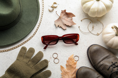 Composition with stylish female accessories and autumn leaves on light backgroundの写真素材