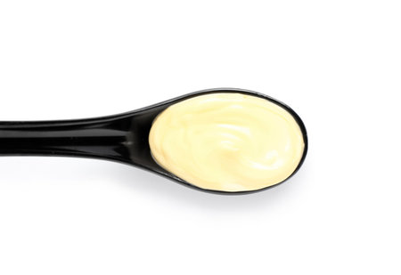 Spoon of fresh mayonnaise on white backgroundの写真素材