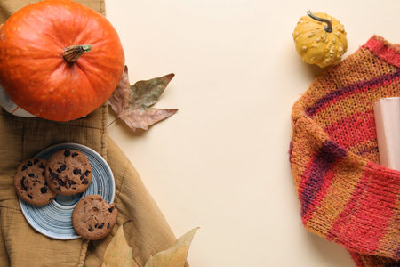 Composition with sweet cookies, pumpkins and clothes on color backgroundの写真素材