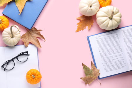 Composition with books, eyeglasses and autumn decor on pink backgroundの写真素材