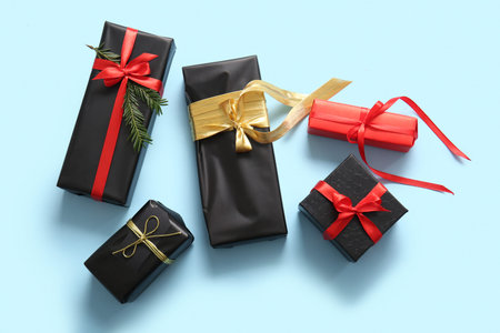 Gift boxes and Christmas tree branch on blue background