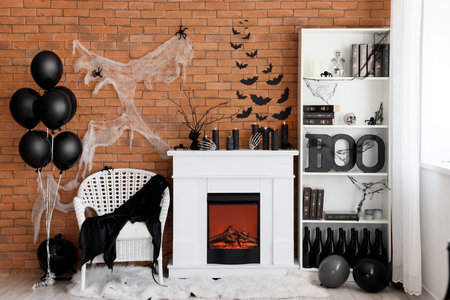 Interior of living room decorated for Halloween with fireplace, armchair and shelf unitの写真素材