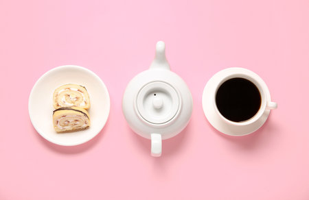 Pieces of sweet sponge cake roll, tea pot and cup with coffee on pink backgroundの写真素材