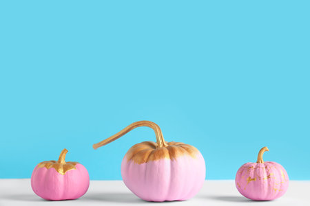 Pink painted pumpkins on colorful backgroundの写真素材