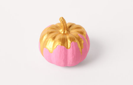 Pink painted pumpkin on white backgroundの写真素材