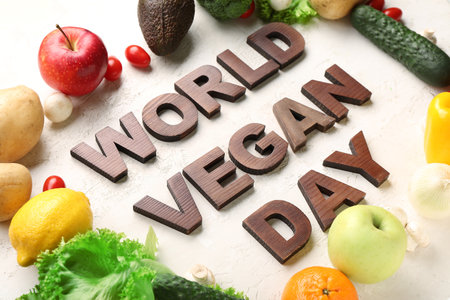 Text WORLD VEGAN DAY with different fresh vegetables and fruits on white backgroundの写真素材