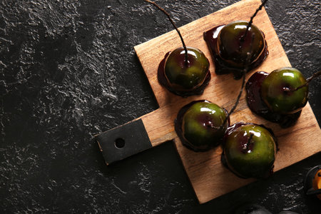 Tasty caramel apples for Halloween on black backgroundの写真素材