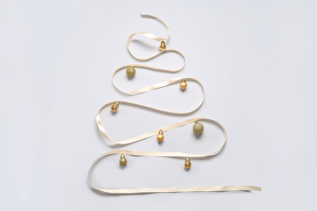 Christmas tree made of balls and ribbon on white backgroundの写真素材
