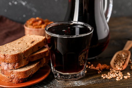 Glass of tasty kvass and bread on tableの写真素材