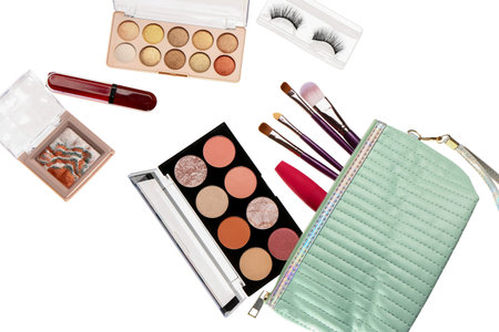 Flying cosmetic bag with makeup products on white background